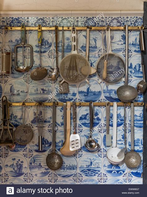 Download this stock image: Kitchen utensils hung on rack with delft tiles behind - EWW6G7 from Alamy's library of millions of high resolution stock photos, illustrations and vectors. Delft Tiles Kitchen, Delft Kitchen, Old Fashioned Bathtub, Yellow Dresser, Dutch Kitchen, Dutch Tiles, Dutch Blue, Delft Tiles, Painted Floor