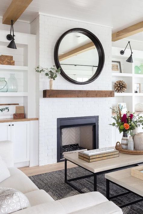 Cottage living room displays a round black mirror and rustic wood floating shelf mantel on a white brick fireplace. White Brick Fireplace, Modern Farmhouse Living Room Decor, Farmhouse Style Living Room, Modern Farmhouse Living, Modern Farmhouse Living Room, Trendy Living Rooms, Design Salon, Farmhouse Decor Living Room, White Brick