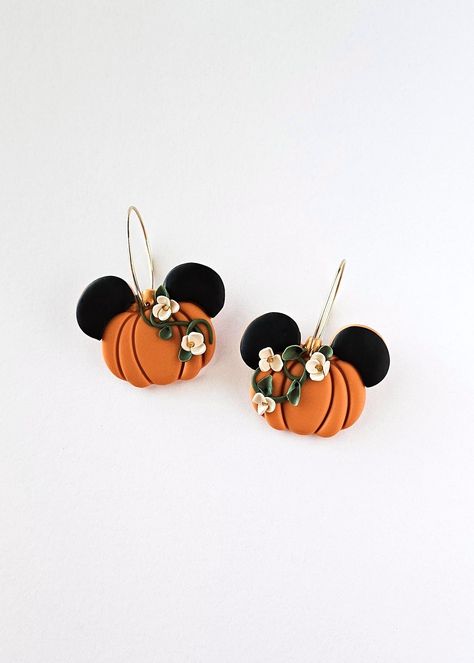 Get ready for the pumpkin season this Fall in these botanical pumpkins with adorable mouse ears. The earrings feature a vibrant orange pumpkin hue and are elegantly styled as hoop dangles with secure latch back closures. Perfect for adding a touch of whimsy to any outfit! 🎃🐭 Each item is designed and crafted by me with passion and care. As the creator, designer, and artist, I take pride in every piece I make. Please keep in mind that, while I hold myself to high standards for quality, handmade items may have slight variations and imperfections that make them one-of-a-kind. So embrace the charm and character that comes with each handmade creation! Follow @clayunico on instagram! Care: All earrings are made of polymer clay, which is a durable and water-resistant material. Maintain the long Disney Clay Earrings Diy, Polymer Clay Fall Ideas, Pumpkin Polymer Clay Earrings, Disney Polymer Clay Earrings, Halloween Earrings Diy, Pumpkin Clay Earrings, Fall Polymer Clay Earrings, Halloween Clay Earrings, Pumpkin Clay