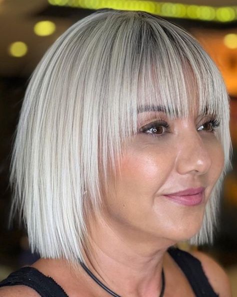 White Blonde Bob with Wispy Bangs and Ends Medium Length Inverted Bob With Bangs, Short Hairstyles With Bangs For Women Over 50, White Blonde Bob With Fringe, Bobs With Wispy Bangs, Platinum Blonde Bob With Bangs, Graduated Bob With Fringe, Bob With Fringe Fine Hair, Cute Wispy Bangs, Blonde Bob With Fringe