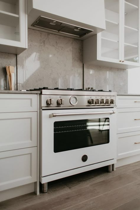 This classic kitchen features a Bertazzoni 36" Master Series range front and center, complemented by a stone backsplash and light cabinetry. Stainless steel accents pair with wood flooring to create a calming kitchen atmosphere. The overall aesthetic speaks to the Parisian design sensibility throughout the home.     (Builder + Design: Bloc53 Developments / Repost: Yeg infill / Photographer: Sharon Litchfield) Bertazonni Range Kitchen, Bertazonni Kitchen, Bertazzoni Range Kitchen, Calming Kitchen, Mandi Design, Bertazzoni Kitchen, Bertazzoni Range, Range Kitchen, Kitchen 2022