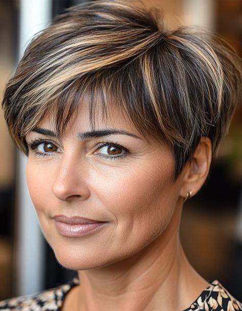 17. Chic Brunette Pixie with Highlights This chic brunette pixie haircut is effortlessly stylish, with subtle highlights that add texture and dimension to the darker base. The short, neat layers keep this look fresh and modern while being super low-maintenance. Brunette Pixie Haircut, Brunette Pixie With Highlights, Pixie With Highlights, Haircut For Women Over 50, Pixie Haircut For Women, Pixie Hair Color, Pixie Haircuts For Women, Brunette Pixie, Layered Haircuts For Women