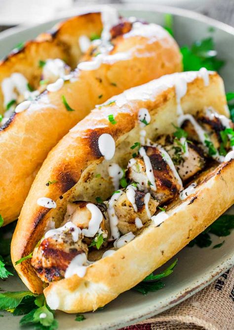 These chicken spiedies are marinated in a lemon, olive oil and herb marinade, grilled and served over Italian rolls, then drizzled with a delicious garlic sauce. Simple, quick and undeniably delicious. Chicken Spiedies, Herb Marinade, Italian Rolls, Chicken Subs, Chicken Tetrazzini, Jo Cooks, Easy Grilled Chicken, Chicken Sandwiches, Lemon Olive Oil