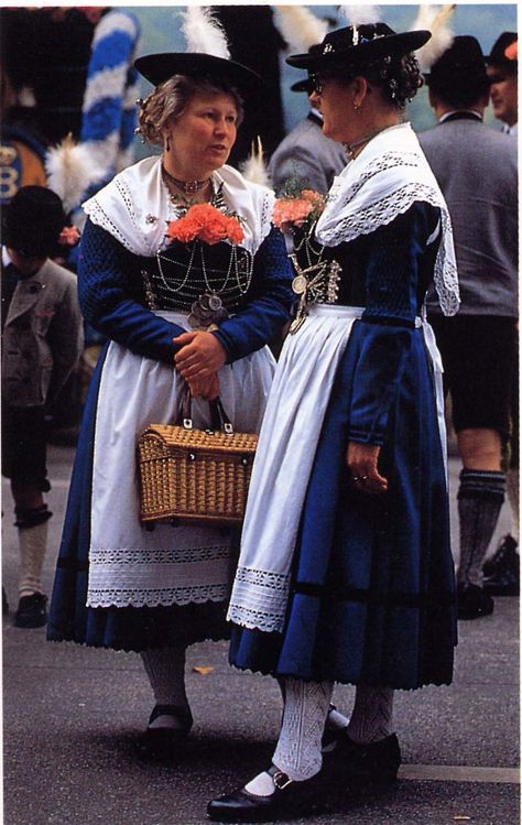 The women wear chain-laced bodices, a major feature of Bavarian dress, as are the hairpins and white lace shawls and aprons. - Ethnic Dress, Frances Kennett Bavarian Traditional Clothing, German Traditional Dress, Bavarian Outfit, Bavarian Costume, Bavarian Dress, Lace Shawls, Costumes Around The World, German Dress, Folk Dress