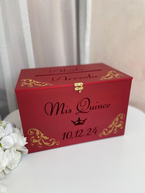 A beautifully designed red engraved wooden money box that adds elegance and sentiment to any special occasion. Perfect as a quinceañera card box, it provides a stylish and secure place to store heartfelt messages, cards, and monetary gifts. Thoughtfully crafted, this keepsake also makes a meaningful sweet 16 gift, offering a timeless way to cherish memories from the celebration. As a piece of personalized quinceañera decor, it enhances the event with its intricate engraving and sophisticated des Money Box Quinceanera, Quinceanera Decor, Quinceañera Decor, Heartfelt Messages, 15th Birthday, Money Box, Card Box, Sweet 16, 20 Cm