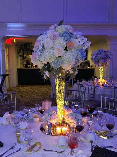 Floral Centerpieces With Fairy Lights, Flower Vase With Lights Centerpieces, Tall Glass Vase Centerpiece With Lights, 15 Flower Centerpieces, Fairy Lights Wedding Centerpieces Flower, Tall Quinceanera Centerpieces, Grand Centerpieces Wedding, Wedding Fairy Lights Centerpieces, Tall Wedding Centerpieces Flowers