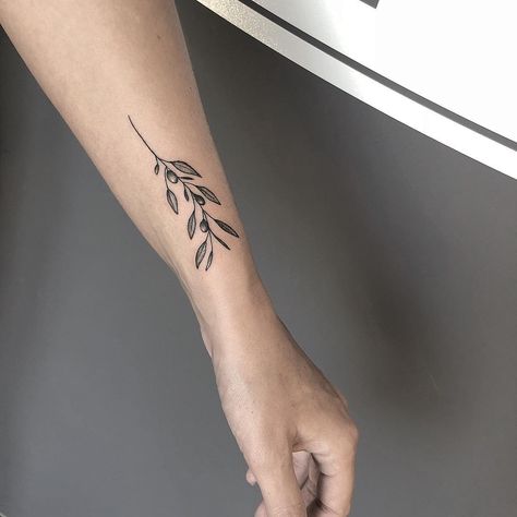 Olive Branch Tattoo Arm Wrap Men, Minimalist Olive Branch Tattoo, Branch Tattoo Wrist, Olive Leaves Tattoo Design, Olive Branch Tattoo Mens, Olive Tree Tattoos, Olive Tattoo, Olive Branch Tattoo, Meaningful Wrist Tattoos