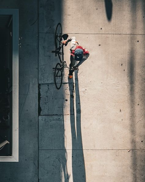 Red’s Bicyclette . Caught from above, amidst the bustling streets of Los Angeles, is a captivating moment frozen in time. In this photograph, we see a lone figure gracefully navigating the urban landscape, gently guiding their bike down the pavement. . The simplicity of this scene belies its profound essence—a reminder of the quiet moments of introspection and exploration that punctuate our daily lives. It’s a glimpse into the rhythm of the city, where each step forward is a journey of discov... Street From Above, Frozen In Time, Cinematic Photography, Quiet Moments, The Quiet, Urban Landscape, The Urban, In Time, Landscape Photography