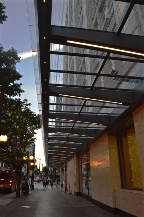 Storefront lighting for marquis retail establishment – KlikUSA Awning Storefront Design, Glass Canopy Design Entrance, Storefront Canopy, Facade Lighting Architecture, Glass Canopy Design, Glass Awning, Awning Design, Canopy Lighting, Renovation Facade