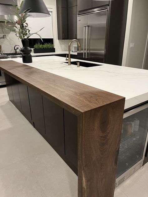 Cement Waterfall Countertop, Modern Kitchen Island With Dining Table Attached, Kitchen Island Mini Fridge, Kitchen Island With Bar Top, Cantilever Countertop, Large Kitchen Peninsula, Waterfall Edge Countertop, 2 Tier Kitchen Island, Walnut And Black Kitchen