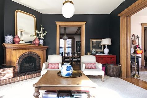 Black Walls, Unpainted Wood Trim, Victorian Living Room | Making it Lovely - Making it Lovely Black Walls Oak Trim, Fireplace Short Ceiling, Red Console Table, Red Kitchens, Farmhouse Reno, Peacock Mirror, Bathroom Design Plans, Above The Fireplace, Pine Trim