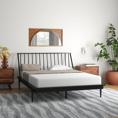 Elevate your bedroom with this mid-century modern bed, featuring a clean-lined spindle headboard and tapered legs for that perfect retro look. Made from solid pine wood, this platform bed offers sturdy support without the need for a box spring. Mattress and bedding are not included. Assembly is a breeze with the included step-by-step instructions, giving your room an instant update. Mercury Row® Size: Queen, Color: Black | Mercury Row® Henline Solid Wood Platform Spindle Bed 40.625 H x 67.5 W x Spindle Bed Frame, Bedroom Furniture Placement, Black Platform Bed, Slat Headboard, Pine Bed Frame, Wood Spindle Bed, Spindle Bed, Platform Design, Slatted Headboard