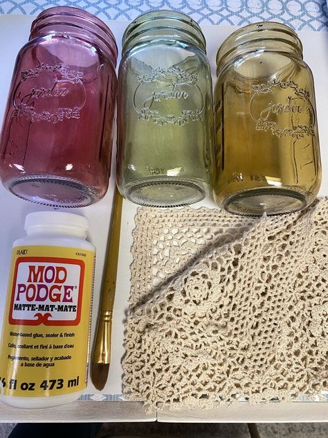 I had these crochet lace pillowcases when I was growing up that I got to match my grandmother's crochet blanket. I haven't used it in years and wanted to do something with it to honor my grandmother. So, this week, I am going to share how I took these old mason jars (from How to Create a Bathroom Wall Mason Jar Organizing Post) and turned them into DIY hurricane lamps. Here are the supplies I used.CUT 7 INCHES OF THE CROCHET LACE PILLOWCASE.Removing the back liner. Make sure to keep… Seniors Crafts, Old Mason Jars, Lace Jars, Diy Essential Oil Diffuser, Lace Mason Jars, Mod Podge Matte, Jar Projects, Mason Jar Organization, Lampshade Makeover