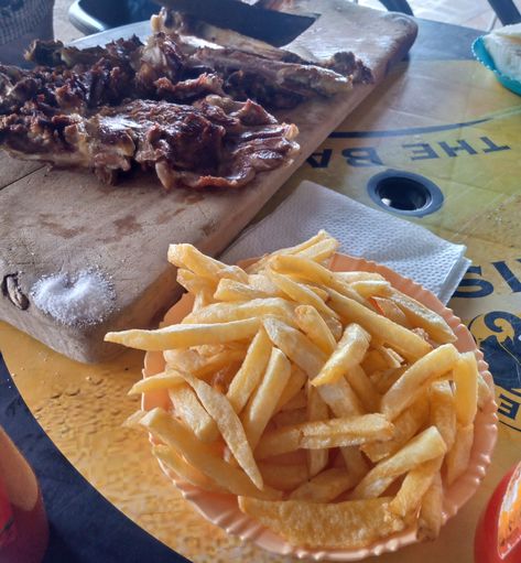 Indulging in the ultimate Kenyan combo: perfectly grilled nyama choma and golden, crispy chips! 🇰🇪🔥 Nairobi's food culture never disappoints. Who else craves this local delicacy? 🍖🍟 

#NyamaChomaVibes #KenyanCuisine #FoodieAdventures #NairobiEats Nyama Choma, Kenyan Food, Crispy Chips, Food Culture, Grilling, Chips