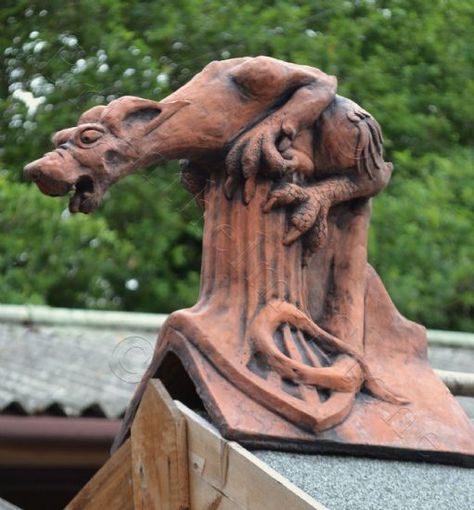 Roof Finials We supply a large range of decorative roof finials including traditional Victorian, dragons, gargoyles, animals and birds on angled and half round ridge tiles. All are hand made in England.  Animal Roof Finials Dragon Roof Finials Gargoyle Roof Finials Copper Roof House, Roof Finials, Angled Roof, Aged Terracotta, Ridge Tiles, Roof Decoration, Victorian Accessories, Storybook Homes, Cement Garden