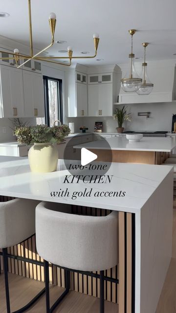 Monika Saran on Instagram: "✨ Kitchen Views an FAQs✨  Floors: Triangulo Brazilian Oak Boreal  Cabinets: Custom made by a local company and painted/stained - white looks like Snowbound by Sherwin Williams. Island stain was color matched to the floor.   Quartz: MSI Surfaces Carrara Breve on the backsplash and first island. Cakcatta Ultra on waterfall island.  Hardware/Pulls: all purchased from Wayfair - type links below and I’ll send links to your DMs.  Bar / Counter Stools : type links below and  I’ll send links to your DMs.  Faucet and Pot Filler: Delta Champagne Bronze color. Type links below for the exact ones I have.  Paneling on waterfall island: Purchased from Lowe’s. I can send you a link.   I’ve linked the lighting and runners too. Let me know if you have any other kitchen questions Delta Champagne Bronze, Waterfall Island Kitchen, Classic Kitchen Cabinets, Waterfall Island, Bar Counter Stools, Instagram Kitchen, Hardware Pulls, Classic Kitchen, White Kitchen Design