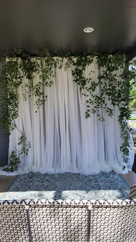 Greenery Garland Backdrop, White Wood Backdrop Wedding, Sheer Backdrop With Greenery, Floral Bridal Shower Decorations Photo Backdrops, Green Photo Backdrop Wedding, White Backdrop With Greenery, Diy Bridal Shower Photo Backdrop, White Curtain Backdrop With Greenery, Hanging Ivy Wedding Decor