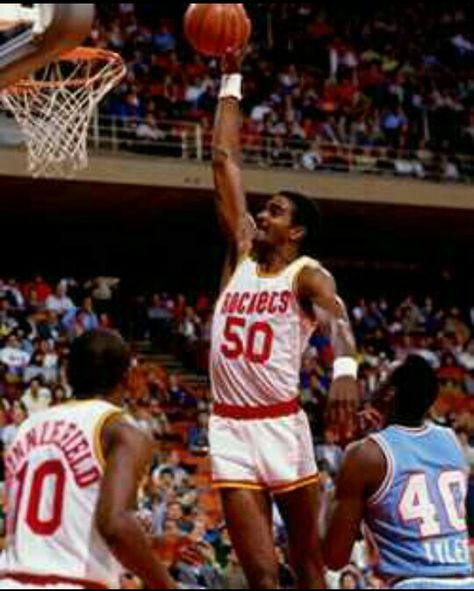 Ralph Lee Sampson, Jr. (born July 7, 1960) is a retired American basketball player. A 7-foot-4 phenom, three-time College Player of the Year, and No. 1 pick in the 1983 NBA Draft, Sampson brought heavy expectations with him to the NBA. The NBA Rookie of the Year, Sampson averaged 20.7 points and 10.9 rebounds for his first three seasons with the Houston Rockets before injuries began to take their toll. Three knee surgeries later he retired a four-time All-Star whose career highlight ended up bei Basketball Dunk, Basketball Court Flooring, Team Usa Basketball, Indiana Basketball, Basketball Uniforms Design, Ralph Sampson, Girls Basketball Shoes, Basketball Schedule, Basketball Highlights