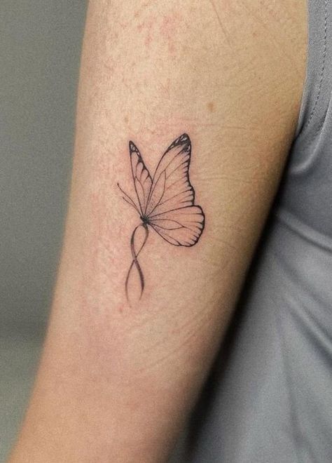 100 Unique Butterfly Tattoo Ideas (Best Butterfly Tattoos) - The Trend Scout Butterfly Awareness Ribbon Tattoo, Butterfly Tattoo With Ribbon, Butterfly With Pink Ribbon Tattoo, Ribbon And Butterfly Tattoo, Purple Ribbon Butterfly Tattoo, Miscarried Butterfly Tattoo, Butterfly With Ribbon Tattoo, Cancerian Butterfly Tattoo, Word Butterfly Tattoo