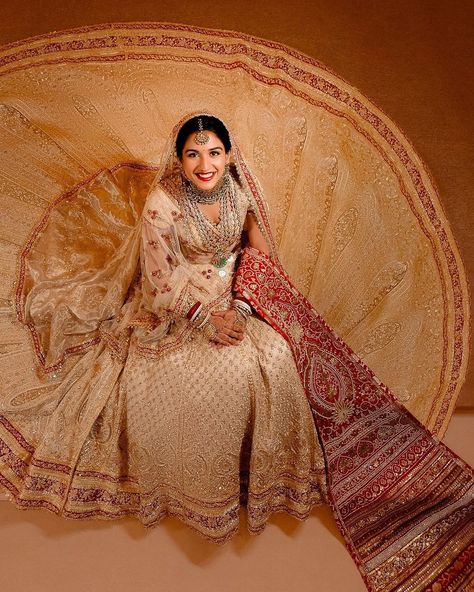 A Fairytale Come to Life - Radhika Merchant wears Abu Jani Sandeep Khosla for her wedding ceremony to Anant Ambani. Radhika’s ensemble is Abu Sandeep’s intricate interpretation of ‘Panetar’ - the Gujarati tradition of brides wearing red and white. The ivory Zardozi cut-work ensemble consists of a trailing ghagra layered with a second detachable trail, a 5 meter head veil and a tissue shoulder dupatta. The ghagra glitters with three borders of red, Its workmanship is the finest amalgamation ... Radhika Merchant Wedding, Radhika Merchant, Anant Ambani, Jewel Wedding, Wedding Lehenga, Lehenga Designs, July 12, Bridal Lehenga, Wedding Looks