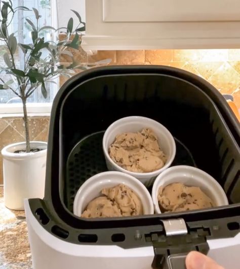 placing ramekins filled with pre-made chocolate chip cookie dough into the air fryer Airfry Cookie Dough, Cookie Ramekin, Air Fryer Ramekin Desserts, Air Fried Cookie Dough, Air Fryer Ramekin Recipes, Cookie Dough In Air Fryer, Nestle Cookie Dough, Chocolate Chip Cookie Bowls, Air Fryer Cookies