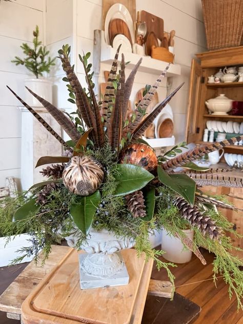 Create A Rustic-Chic Greenery and Pheasant Feather Centerpiece Christmas Tree Pheasant Feathers, Pheasant Tail Feathers Decor, Pheasant Flower Arrangements, Pheasant Feather Crafts Diy, Pheasant Feather Decor Diy, Pheasant Tail Display, Pheasant Feather Centerpieces, Crafts With Feathers, Pheasant Wedding