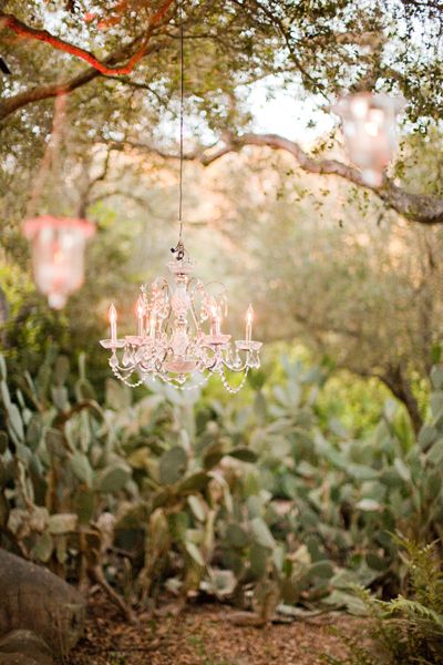 23 Charming Chandelier Ideas for Your Garden Chandelier Hanging From Tree Wedding, Chandelier In Garden, Chandelier Hanging From Tree, Chandeliers In Trees, Chandelier Outdoor Wedding, Outside Chandelier Ideas, Garden Chandelier Ideas, Chandelier In Tree, Outdoor Chandelier Ideas