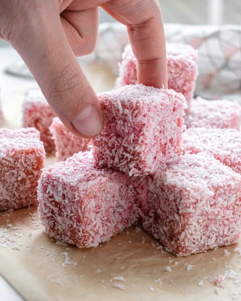 Pink lamingtons are soft and fluffy sponge cakes soaked in jelly and covered with coconut. Originally from Australia this treat has found it’s way to Malta were it’s found at every bakery. Pink Lamingtons Recipe, Lamingtons Cake, Snowball Cake Recipe, Lamington Cake Recipe, Lamington Recipe, Pink Party Food, Danish Butter Cookies Recipe, Snowball Cake, Lamington Cake