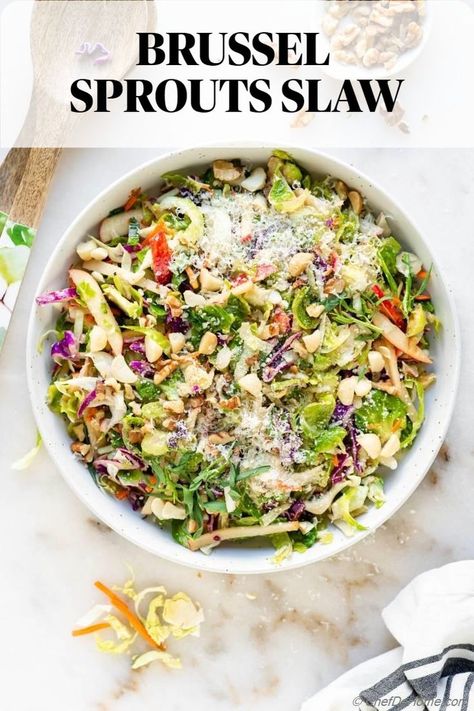 Refreshing Brussel Sprouts Slaw with cabbage and apple tossed in lite mustard dressing. With nutty parmesan cheese and crunchy roasted nuts, this recipe is upgrade to your favorite classic coleslaw. #BrusselsSlaw #HealthyEating #PlantBasedDiet #BrusselSprouts #TastyTreat #VegetarianDish #HealthyMeals #GreensGalore #CookingHealthy #YummyVeggies #PinterestRecipes #LabourDayRecipes Brussel Sprout Slaw, Autumn Salad Recipes, Shredded Cabbage, Shredded Brussel Sprouts, Vegetarian Salads, Brussel Sprout Salad, Delicious Magazine, Slaw Recipes, Autumn Salad