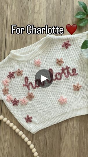 143K views · 9.2K reactions | How to embroider a flower on a knitted sweater using yarn. This is a lazy daisy stitch and is perfect for little flowers all over a sweater or to make an entire letter.

This is our pearl sweater with rose, blush, and champagne yarn. Featuring our floral first letter name design with flowers all over!

@luna.and.june for the great spice lid tip!! Go give her a follow!!
.
.
.
.
 #colorado #embroidery #handembroidery #yarnembroidery #mamaandme #personalizedbabyclothes #babyshower #babyshowergift #newbornoutfit #announcementoutfit #newbabyannouncement #babynamesweater #customsweater #namesweater #embroideredsweater #coloradomoms #hospitalbag #firstbirthday#coloradosmallbusiness #womanownedbusiness #kidsclothing #embroiderydiy #genderneutral #embroiderytutorial #c How To Embroider Flowers On Sweater, Hand Embroidery Name Sweater Diy, Diy Flower Embroidery On Knit Sweater, Sweater Embroidery Ideas, Sweater With Embroidered Flowers, Colorado Embroidery, Hand Embroidery Rose, Baby Sweater Embroidery Name, Pearl Sweater