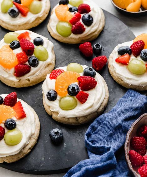 These scrumptious cookies are a perfect miniature version of your favorite fruit pizza! A soft cream cheese sugar cookie topped with lemony cream cheese frosting and your choice of tasty fruits. A refreshing and delightful dessert! Fruit Pizza Cookie Recipe, Fruit Pizza Cookies, Fruit Sugar Cookies, Mini Fruit Pizzas, Cream Cheese Sugar Cookies, Fruit Pizza Sugar Cookie, Plain Cookies, Cookie Pizza, Dessert Pizza