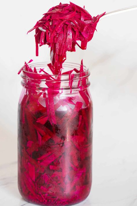 Vibrant homemade raw pickled beets are tangy, delicious, so good for you, easy to make, and ready to enjoy after a day in the refrigerator! Thinly sliced beets are covered in a hot brine of vinegars, water, salt, pickling spice, and a bit of sugar. Enjoy them on salads, sandwiches, or on their own when you're craving superfood with a kick. When they're gone, use the brine to make gorgeous pink pickled eggs. Grated Pickled Beets, Pickled Shredded Beets, Pickled Items, Healthy Condiments, Quick Pickle Recipe, Pickle Seasoning, Pickled Beets Recipe, Pickled Foods, Pickled Turnips