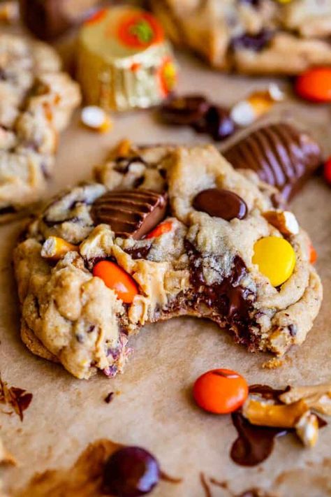 Outrageous Pretzel Reese's Peanut Butter Cookies from The Food Charlatan. These decadent cookies are soft, chewy, and irresistible! A peanut butter cookie dough packed with chopped pretzels, Reese's cups, Reese's Pieces, peanut butter chips, dark chocolate chips, and optional peanuts make these the peanut butter cookies of your dreams! The pretzels do not get soggy in the dough, they maintain their snap and crunch even after chilling or freezing the dough. These are great to make with kids! Peanut Butter Cup Pretzel Cookies, Peanut Butter And Hershey Kiss Cookies, Cookies Using Pretzels, Crumble Reeses Peanut Butter Cookies, Reeses Baking Cups And Pieces Recipes, Peanut Butter Reeses Pieces Cookies, Stuffed Reeses Cookies, Reese Pieces Peanut Butter Cookies, Cookies For Potluck