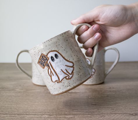 Boo! Oh sorry didn’t mean to scare you! Want a ghost mug? Link to my shop is in my bio! I’ve been a little bit of a ghost lately, but I’ve been working on a lot of exciting stuff for a shop update next week! Stay tuned for pics and more information on the update! #boo #ghostmug #pottery #ceramics #halloween #halloweendecor #fall #mugs Ceramics Halloween, Bat Mug, Fall Mugs, Ghost Mug, A Ghost, Pottery Ceramics, Next Week, Stay Tuned, Halloween Decorations