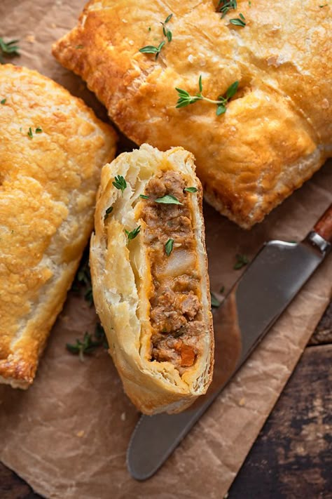 Hot and flaky, these savory hand pies are brimming with a rich, saucy filling of ground beef, diced potatoes, veggies and fresh thyme! | thecozyapron.com #savoryhandpies #savoryhandpiesrecipes #savoryhandpieseasy #savoryhandpiesmeat #savoryhandpieswithpremadepiecrust Ground Beef Hand Pies Puff Pastries, Shepherds Pie Hand Pies, Sausage Hand Pies, Ground Turkey Hand Pies, Savory Turnover Recipes, Handheld Meat Pies, Handheld Pies Savory, Beef Pies Recipes, English Hand Pies