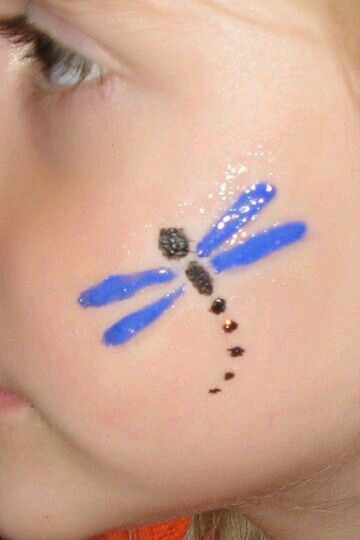 Dragon fly Cheek Painting, Easter Face Paint, Easy Face Painting Designs, Bodysuit Tattoos, Painting Ideas For Kids, Festival Face Paint, Cheek Art, Face Painting Tutorials, Festival Face