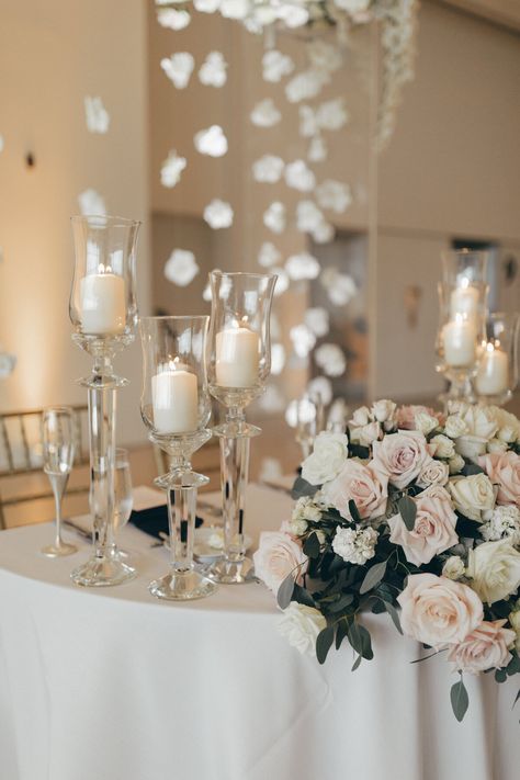 sweetheart table, wedding candles and flowers, sweetheart table design, floating floral, wedding candles, glass candle holders, white and blush wedding, white roses, blush roses, rose centerpiece #luxurywedding #everlieco #weddingcenterpiece #whitecenterpiece #blushcenterpiece #weddingreception Flowers Sweetheart Table, Wedding White Roses, White And Blush Wedding, Blush Centerpiece, Classic And Elegant Wedding, Rose Centerpiece, Candles And Flowers, Sweetheart Table Wedding, White Centerpiece