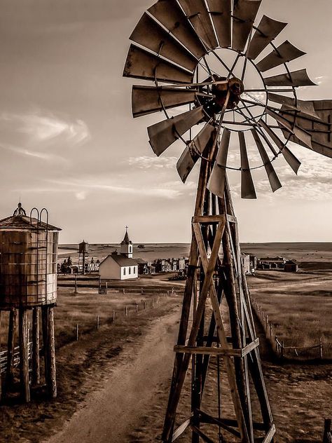 An old windmill standing as a sentinel over the old town on the western frontier. Description from finearta… | Western photography, Old western towns, Western photo Western Aesthetic Wallpaper, Old Western Towns, Old West Town, Country Backgrounds, Western Photo, Old Windmills, Cowboy Aesthetic, Western Artwork, Western Photography