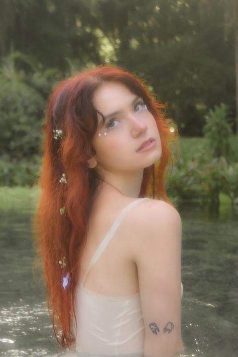 @libbyk.photography on instagram rock springs kelly park florida white nightgown dress baby’s breath in hair river red hair bouquet bows in hair ribbons nature photoshoot fairy mermaid nymph aesthetic Fairy River Photoshoot, Kelly Park Florida, Red Hair Fairy, Bows In Hair, Visual Grammar, Kelly Park, Garden Of Lights, Fairy Photoshoot, Nightgown Dress