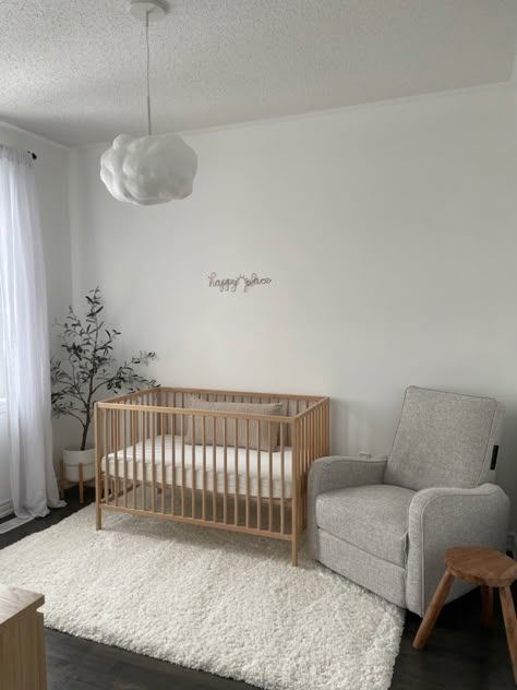 Simple Minimalist Nursery, Nursery Room Minimalist, Nursery Dark Floors, Apartment Friendly Nursery, Simple Small Nursery Ideas, Neutral Nursery Aesthetic, Minimal Neutral Nursery, Dark Floor Nursery, Beige Crib Nursery