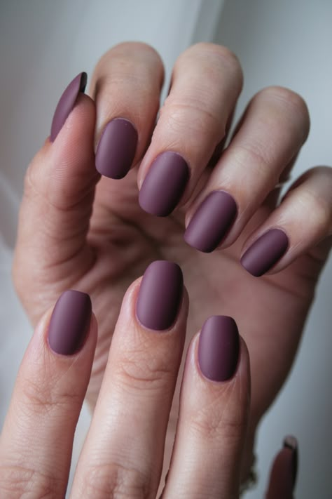 Embrace the season with this stunning matte plum nail design! Perfect for fall fashion lovers, this trendy, minimalist look brings a touch of elegance to your nails. The rich, muted tone is ideal for autumn and pairs beautifully with any cozy fall outfit. Get inspired by this chic fall nail idea and elevate your style with this simple yet sophisticated design! Soft Autumn Nails Color Palettes, Matte Plum Nails, Fall Season Nails Short, Matte Fall Nails Short, Autumn Matte Nails, Dark Purple Nails Designs, Dusty Purple Nails, Plum Fall Nails, Purple Fall Nails Design