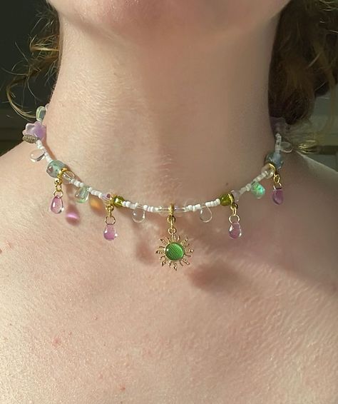 Gaia’s light choker (adjustable) $35.00 Now available 🌳🌞🌷🍃🪻🤍 #sunlight #sun #forest #green #purple #purpleaesthetic #fairy #fairies #teardrop #teardrops #gemstones #gemstonejewelry #literature #dragons #dragon #greekmythology #beadsjewelry #cottagecore #fairycore #smallbusiness #smallbusinessowner #smallbusinesssupport #flowers #flower #flowerjewellery Handmade Fairy Jewelry, Fairy Beaded Jewelry, Fae Costume, Fairy Outfit, Fairy Jewelry, Beaded Jewlery, Fairy Necklace, Purple Jewelry, Fairy Fashion