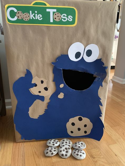 Homemade Cookie Monster cookie toss game for Sesame Street party. Cookie Monster Games Party Ideas, Cookie Monster Activities For Preschool, Sesame Street Party Activities, Cookie Monster Party Games, Sesame Street Activities Toddlers, Cookie Monster Activities, Sesame Street Crafts For Toddlers, Sesame Street Birthday Games, Sesame Street Party Games