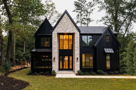 Black siding and windows accented with stone entrance White House Black Stone Exterior, Black House With Stone Accents, Black Brick Homes Exterior, Black Siding House Exterior, Black House With White Stone, Black And Stone Exterior, Stone And Black House Exterior, White Black House Exterior, Black House With Stone