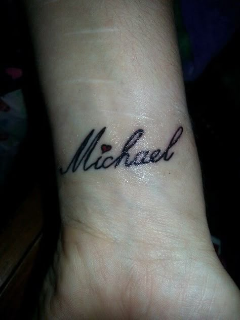 My husband's name Michael Tattoo. On my wrist. Micheal Tattoo Name, Michael Tattoo Name Fonts, Michael Name Tattoo Design, Mike Name Tattoo Design, Michael Name Tattoo, Tattoo Name On Wrist, Michael Tattoo Name, Small Boyfriend Name Tattoos For Women, Michael Tattoo