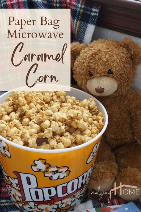 teddy bear is ready for movie night with a blanket, Christmas movies and a large bucket of caramel corn Microwave Carmel Corn In Paper Bag, Carmel Popcorn Microwave, Carmel Puffcorn Recipe Microwave, Carmel Puff Corn, Microwave Carmels, Carmel Corn Recipe, Popcorn In A Bag, Microwave Caramel Popcorn, Puffed Corn Recipes