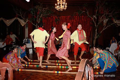 The filipino folk dance called "tinikling," is a traditional filipino dance. It involves both men and women with sets of bamboo sticks sometimes crossed over each other. The bamboo sticks are hit together and on a ground usually in a rhythmic tune while the dancers step back and forth in between the spaces . Tinikling involves more props, feet movement and singing while Islamic dancing has many hand movements and very up-beat music. Filipino Folk Dance, Filipino Dance, Philippine Traditions, Cool Powerpoint Backgrounds, Culture Identity, Hand Movements, Muslim Culture, Powerpoint Backgrounds, Philippine Art