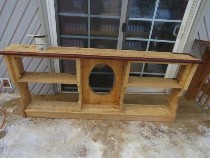 I found an old waterboard headboard this summer at a yard sale and purchased it for $10.00, wait till you see what I did with it. Here is a picture of the headboard before I started to remake it into a TV stand. The first thing I did was sand down the entire piece. Once I had it sanded, I stained the top and the center section with the oval with American Chestnut stain. This is how it looked after staining the top and center section. The next step was painting the rest of the p… Bookcase Headboard Makeover, Waterbed Headboard, Headboard Makeover, Wall Vase Decor, Rocking Chair Makeover, Desk Makeover Diy, Chestnut Stain, Geometric Tray, Diamond Tufted Headboard