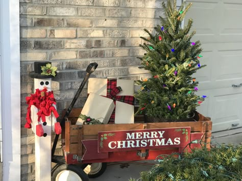 Front porch decorated for Christmas using the kids old wagon. Wagon Decorated For Christmas, Christmas Tree In Wagon, Christmas Greenery Decor, Wagon Decor, Christmas Wagon, Christmas Porch Decorating Ideas, Holidays Decorations, Primitive Country Christmas, Christmas Country