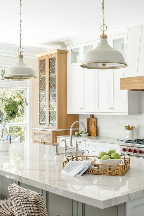 White and gold lanterns illuminate tan wicker stools at a gray kitchen island topped in gray quartzite and a sink with a nickel faucet. Traditional Kitchen Renovation, Kitchen Island Finishes, Marble Top Kitchen Island, Tan Kitchen, Beach Style Kitchen, Blue Kitchen Island, Kitchen Island Tops, Grey Kitchen Island, White Kitchen Island